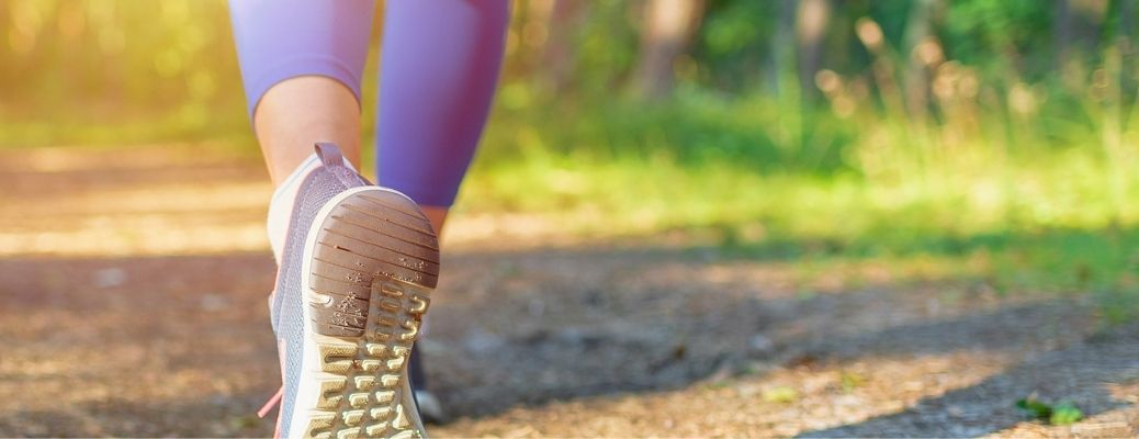 image of a woman's shoes walking in grass