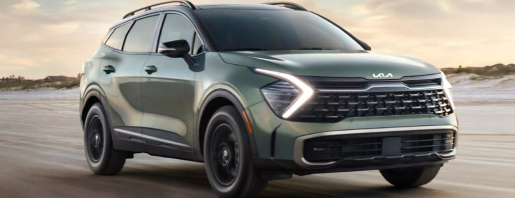 A 2024 Kia Sportage backdropped by the evening sky