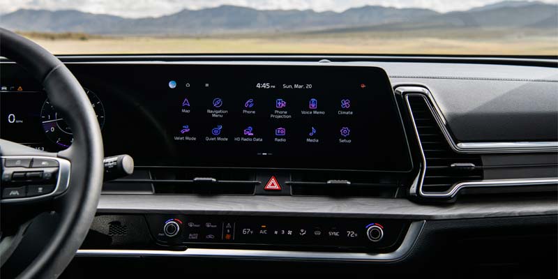 Interior dashboard of the 2025 Kia Sportage featuring a wide digital display and modern infotainment system.