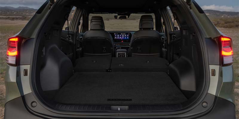 Rear cargo area of the 2025 Kia Sportage with seats folded down, showing spacious trunk capacity.