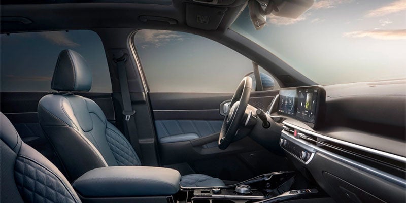 Front cabin interior of an SUV showing the driver seat, dashboard, and touchscreen.
