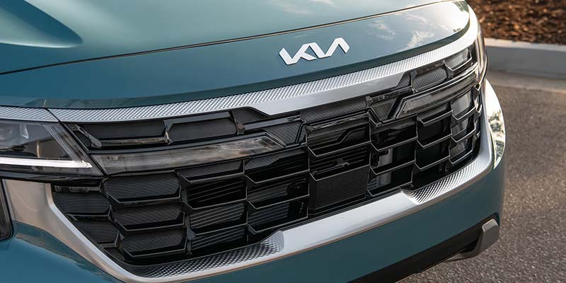 Close-up of the Kia Seltos front grille with Kia logo.